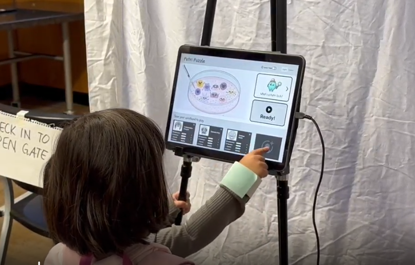 Child interacting with an exhibit screen during testing